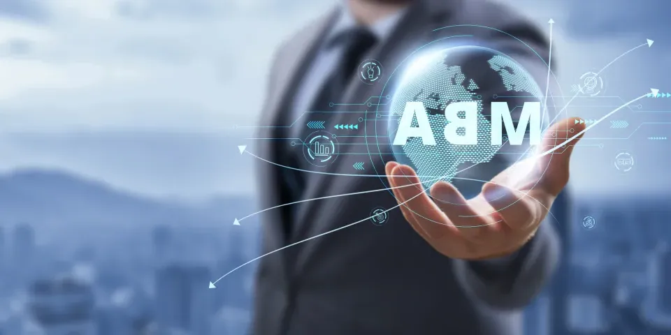 Man in a suit holding globe with MBA superimposed on top